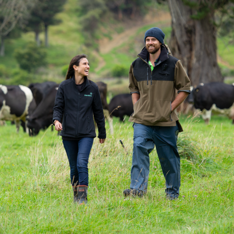 Farmer walking with a Meridian staff memeber