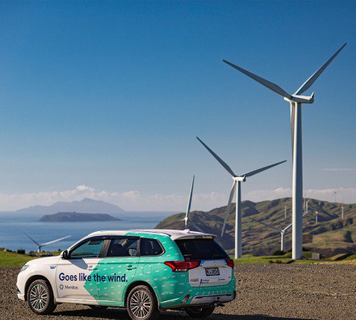 Meridian car in front of a wind farm