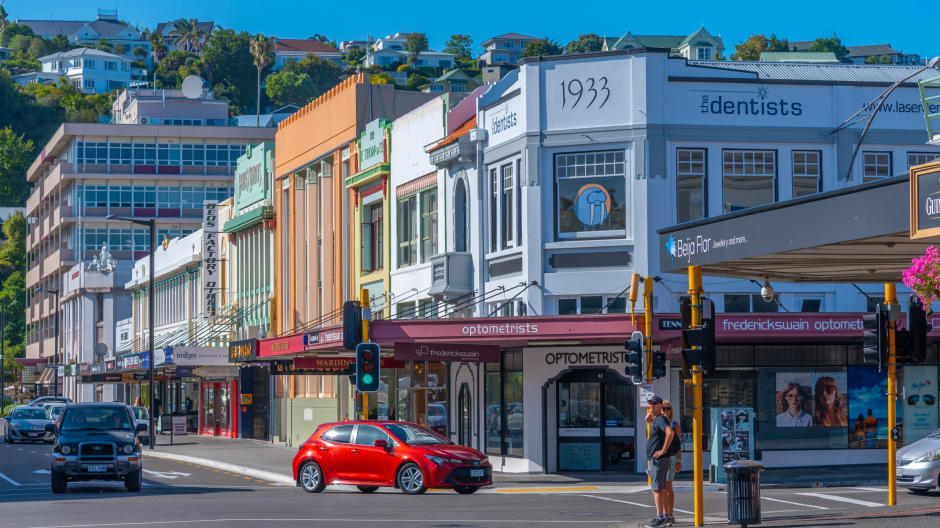 EV driving through Napier/on waterfront with art deco buildings 